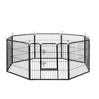Black 8-panel pet playpen set up as an octagon on wooden floor, ideal for small dogs or puppies.