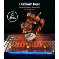 Close-up of grill burner with piezo electric twist ignition and grease collection tray underneath.