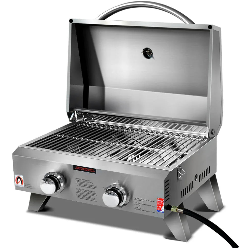 Closed portable 2 burner stainless steel gas BBQ with carry handle on a white background.