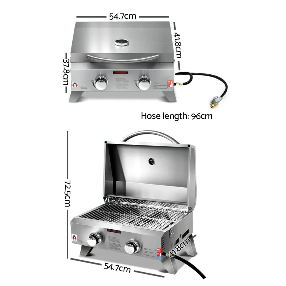 Open portable gas BBQ showing two stainless steel burners and cooking grates.