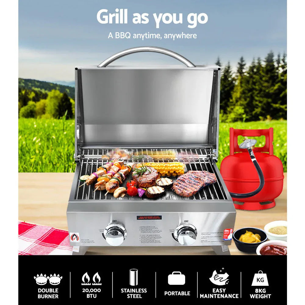 Side view of stainless steel portable gas BBQ with folded legs and handle.