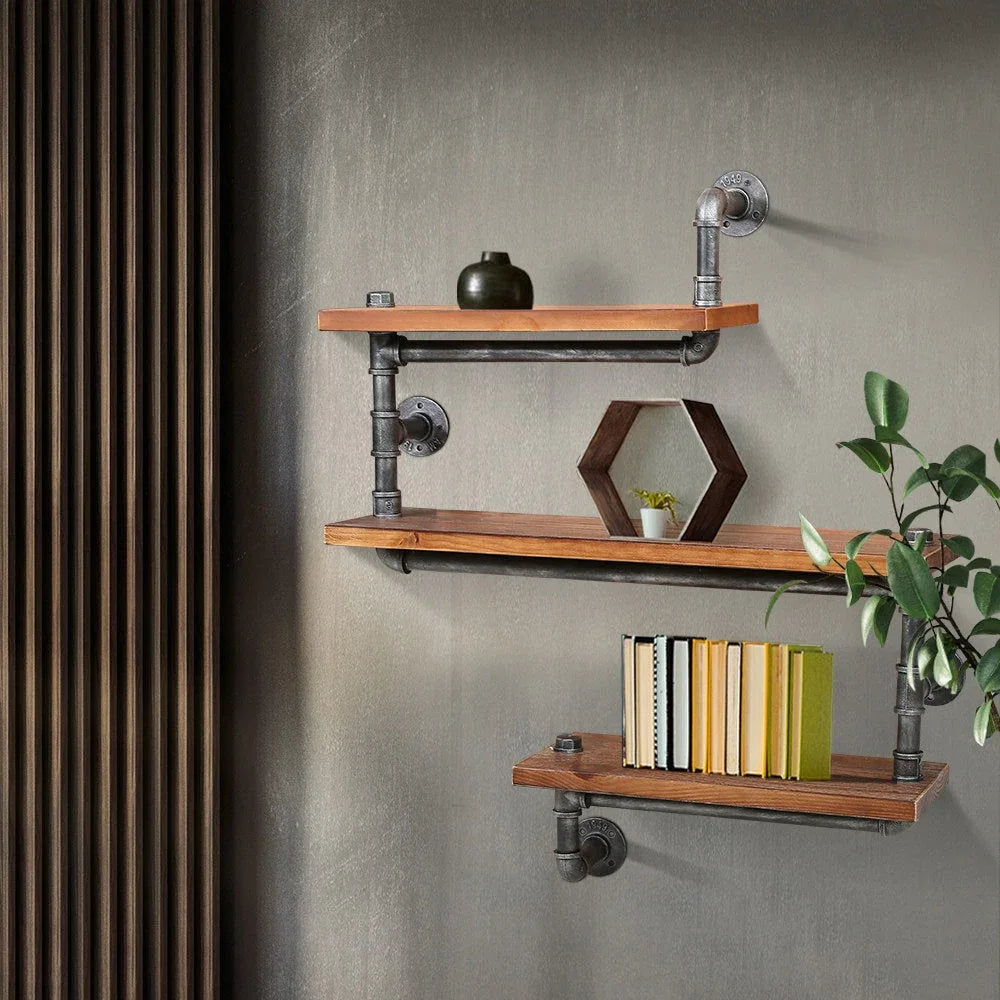 Rustic industrial pipe shelf displayed empty highlighting design and materials on white wall