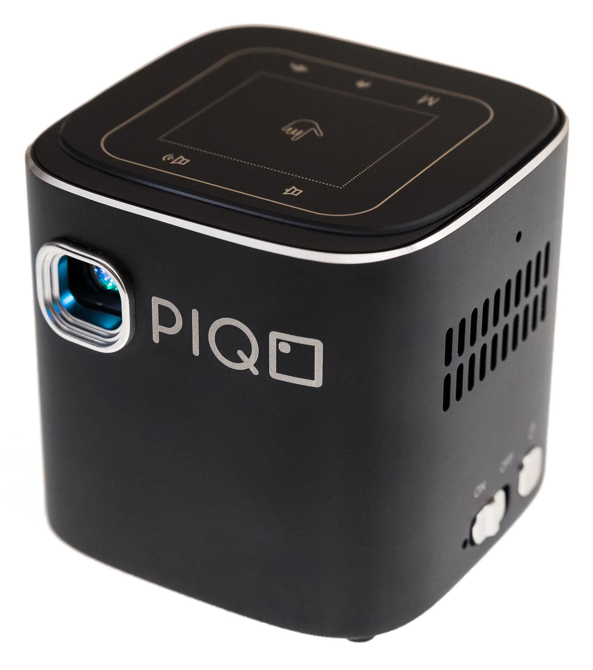Compact PIQO mini projector projecting a bright image on a wall in a dim room.