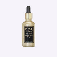 Bottle of PRAI Beauty 24K Gold Retinol Night Drops with gold accents on the label against a white background