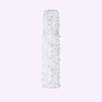 Ageless Throat Activating Serum bottle with pearl design packaging by PRAI Beauty on white background
