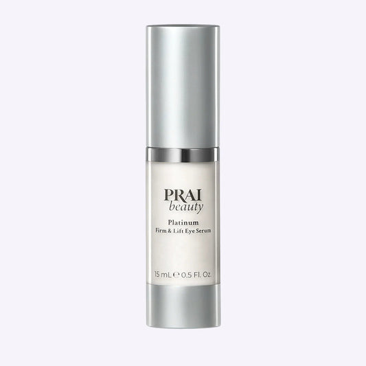 15ml bottle of PRAI Beauty Platinum Firm & Lift Eye Serum with silver and white packaging
