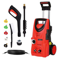 Electric pressure washer with hose and spray lance on green grass background.