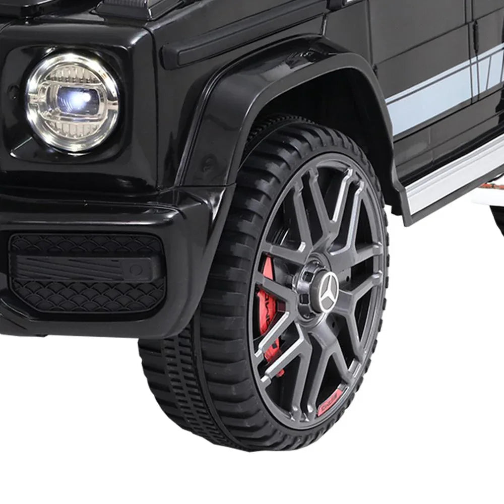 Open door view of black Mercedes-Benz AMG G63 kids ride on car revealing seat interior