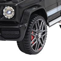 Open door view of black Mercedes-Benz AMG G63 kids ride on car revealing seat interior