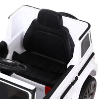 White kids ride-on AMG G63 electric car angled view highlighting design and suspension