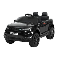 Black kids ride on Land Rover Evoque electric car with headlights on, viewed from front left.