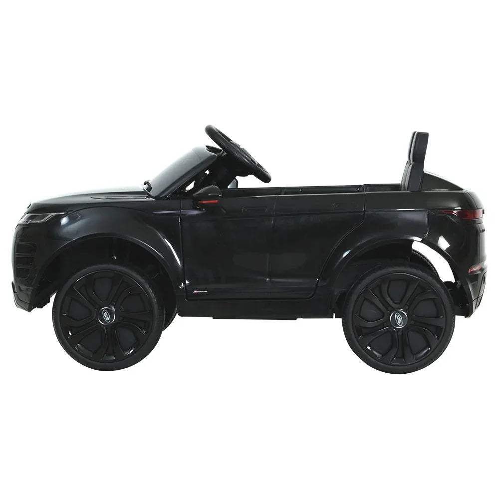 Close-up of black kids electric ride on car’s steering wheel and dashboard details.