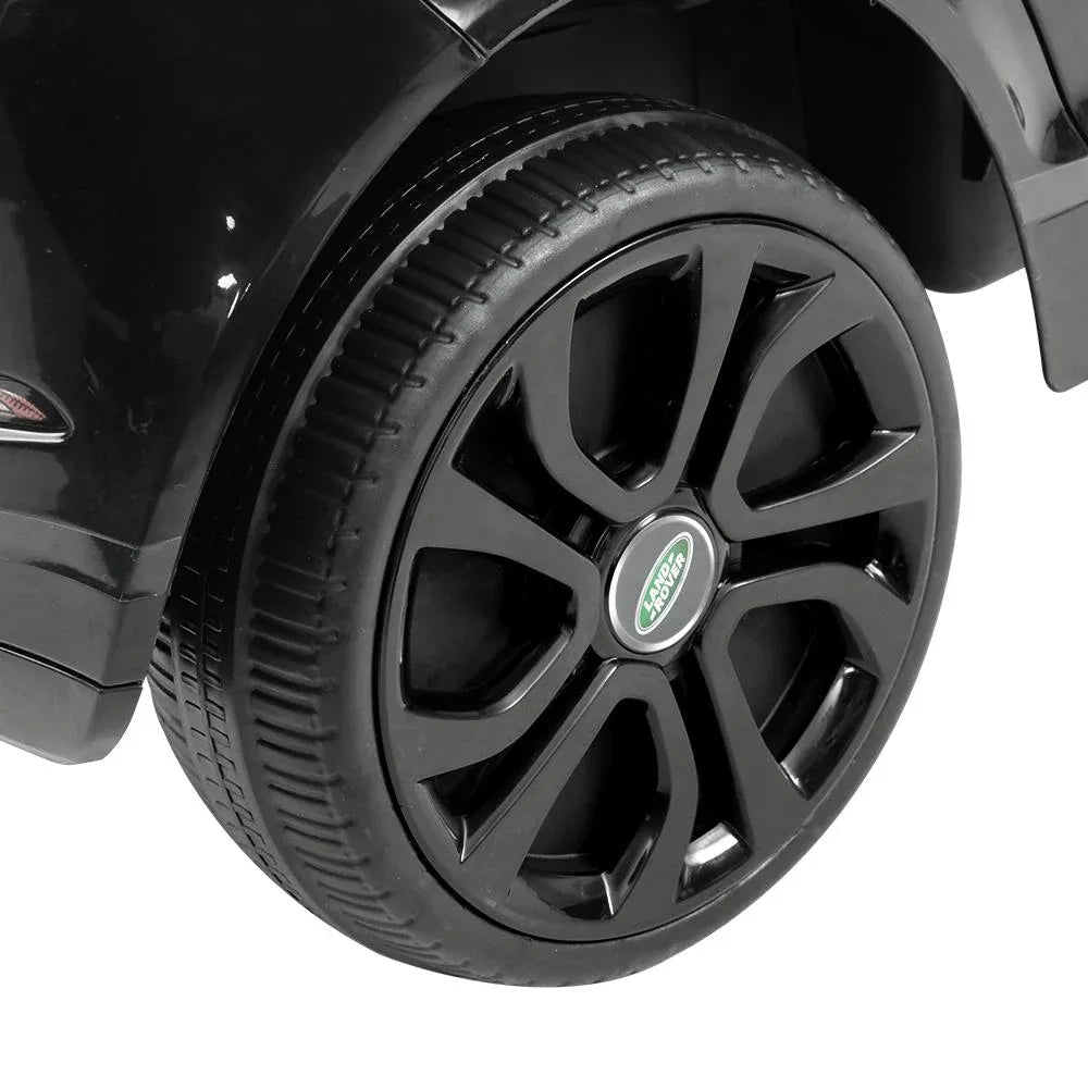 Black kids ride on Land Rover Evoque electric car front with open door and visible seat.