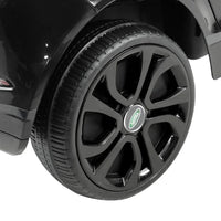 Black kids ride on Land Rover Evoque electric car front with open door and visible seat.