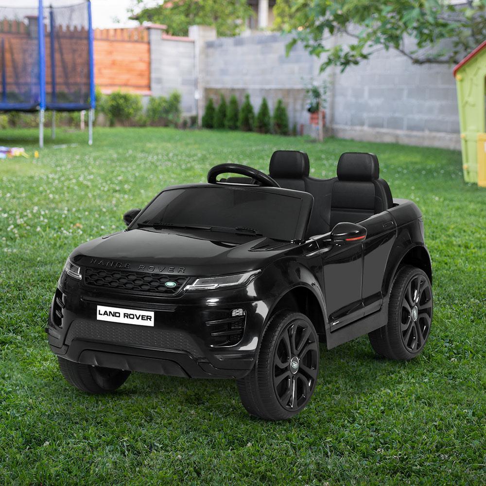 Side angle of black electric ride on Land Rover Evoque showing wheels and body details.