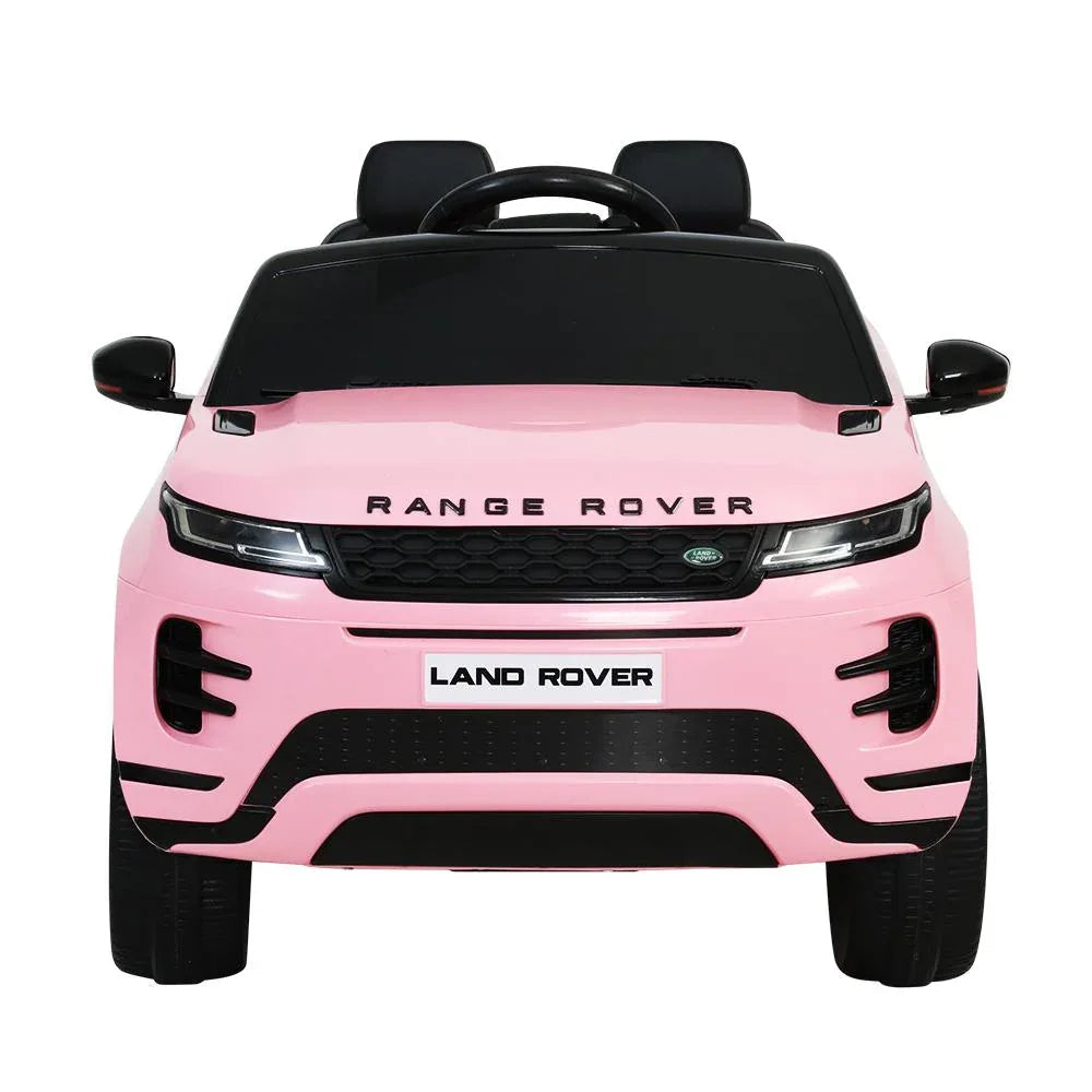 Top-down angled view of red kids electric ride-on Land Rover Evoque car toy with steering wheel visible
