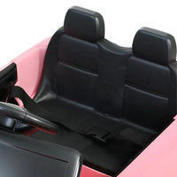 Close-up of the dashboard and steering wheel of the kids electric ride-on Land Rover Evoque car toy