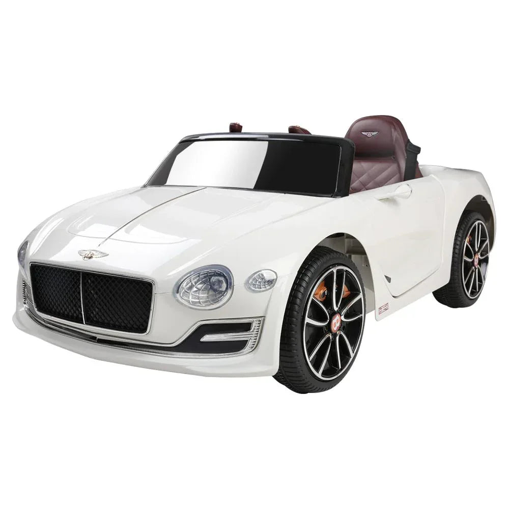 Front angle view of white Bentley Kids Ride On Car with realistic details and headlights on display.