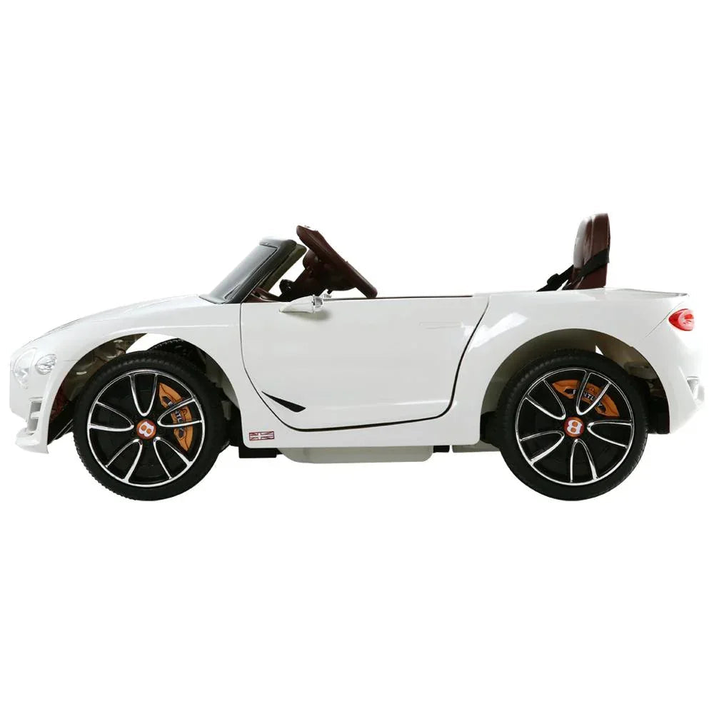 Top view of white kids electric ride on car highlighting steering wheel and seat design.