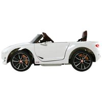 Top view of white kids electric ride on car highlighting steering wheel and seat design.