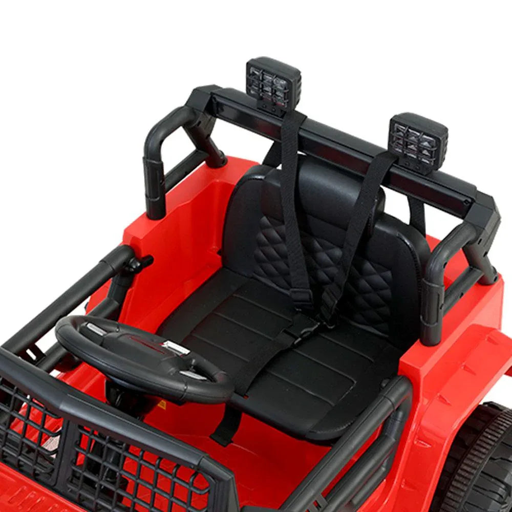Close-up of steering wheel and dashboard interior in red kids electric jeep.