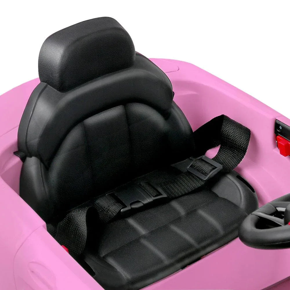 Close-up of front grille and headlights on pink ride-on electric car.