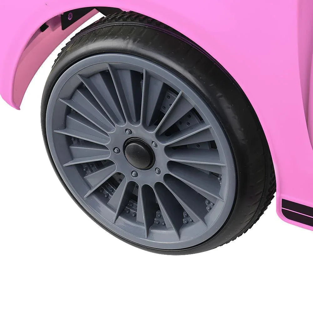 Pink electric kids' car shown with remote control feature in hand.