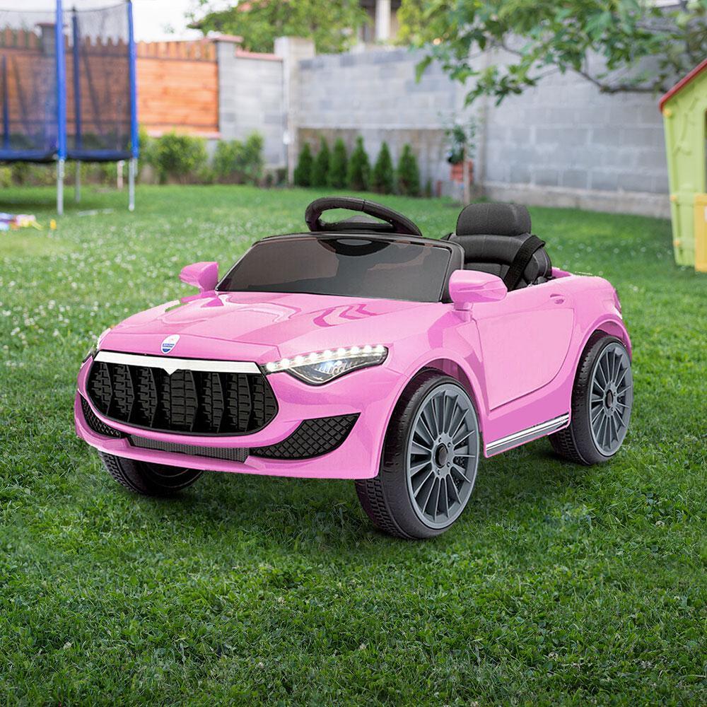 Pink ride-on car with remote control placed on a tiled floor indoors.