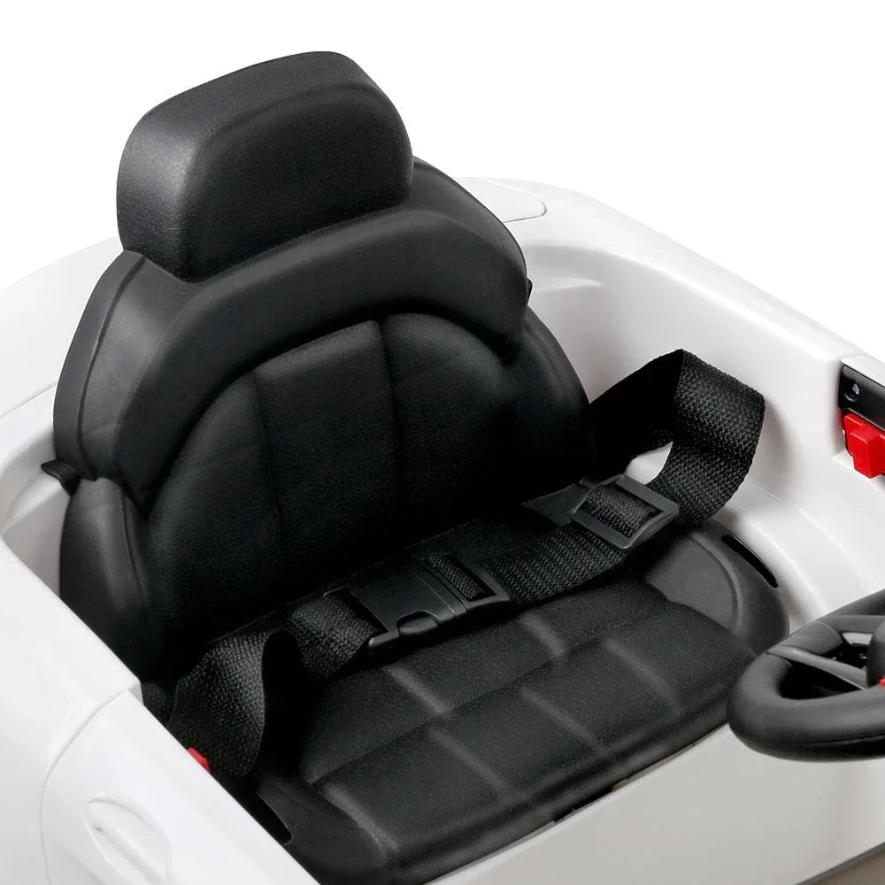 Interior shot of kids ride on car featuring detailed dashboard and steering wheel.