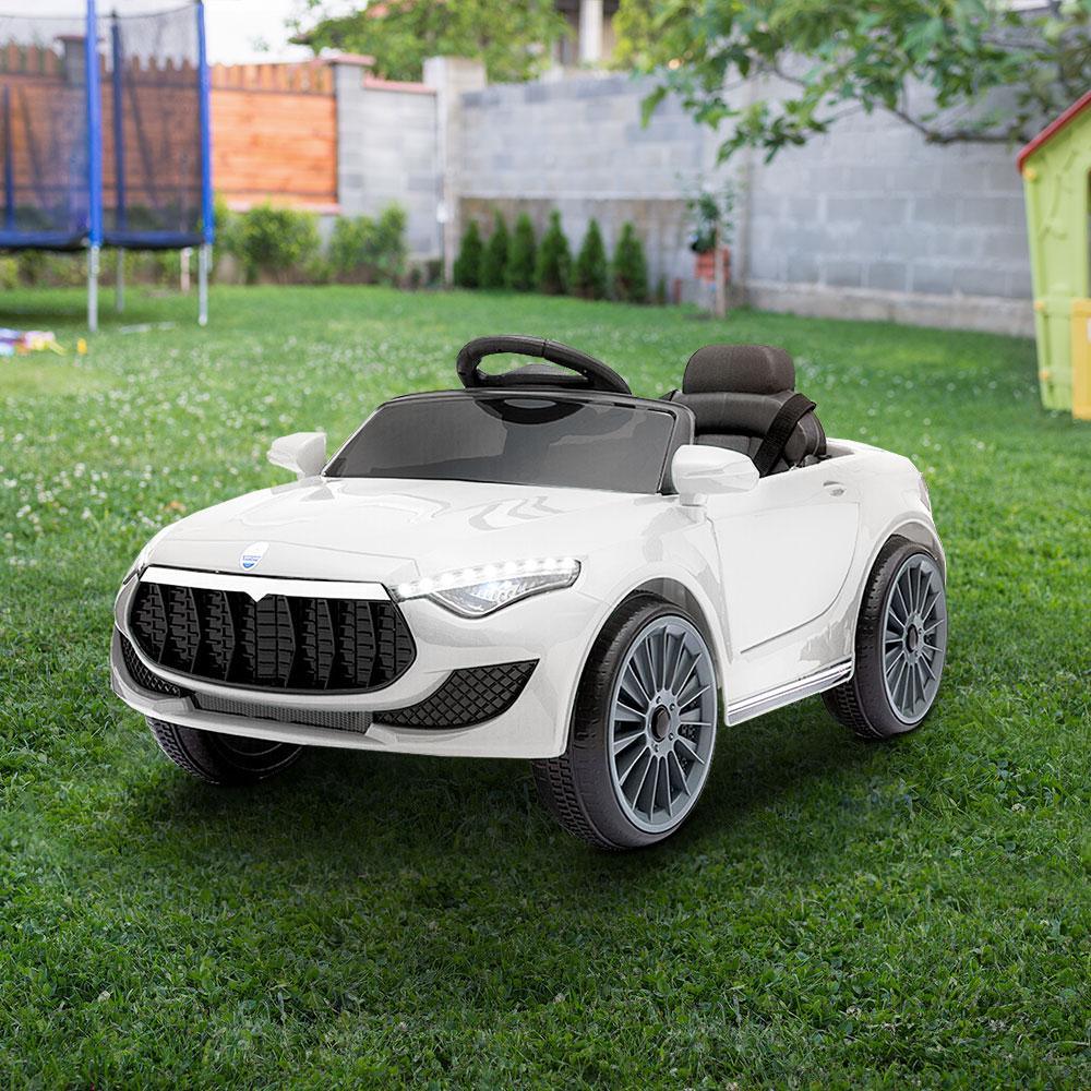 White kids ride on car angled rear view, highlighting rear lights and sleek body.