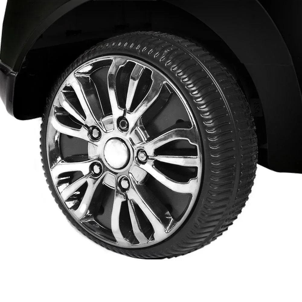 Kids electric ride-on car in black with visible pedals and rugged wheels for outdoor fun.