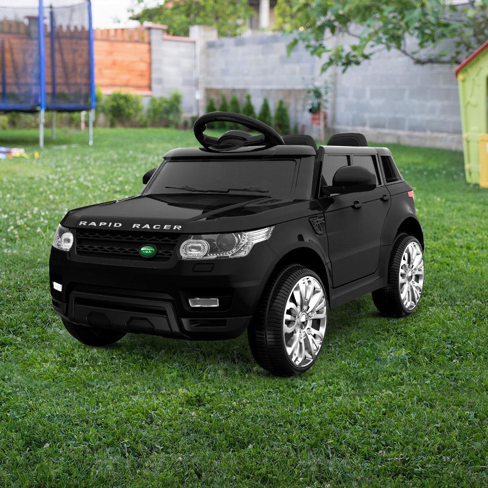 Top-down angled view of black ride-on car highlighting ergonomic seat and dashboard.
