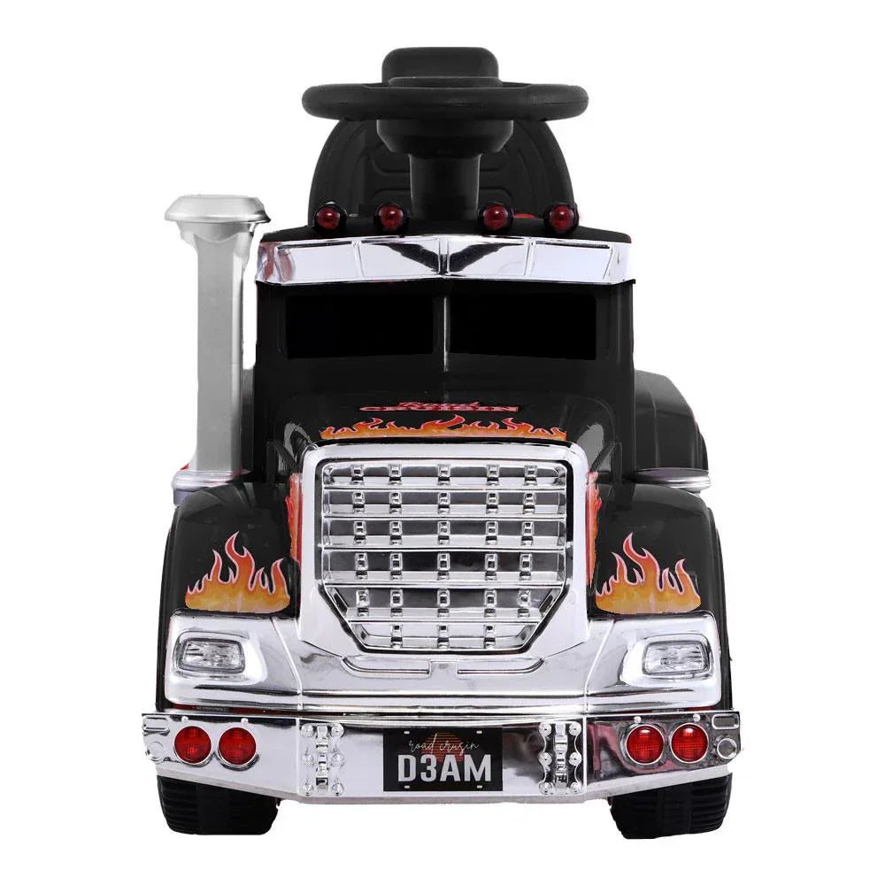 Close-up of black kids’ electric truck dashboard and control panel with steering wheel.