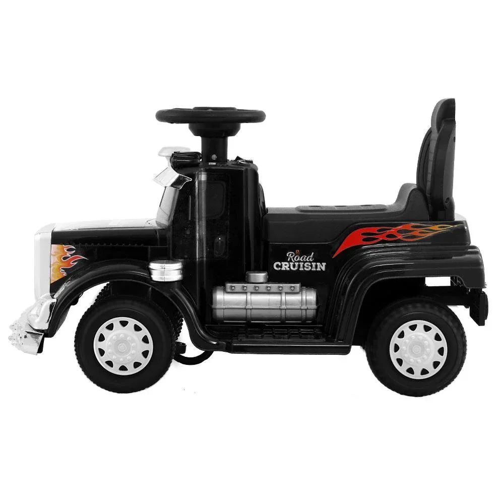 Rear-side view of black ride-on electric toy truck showcasing taillights and rear design.