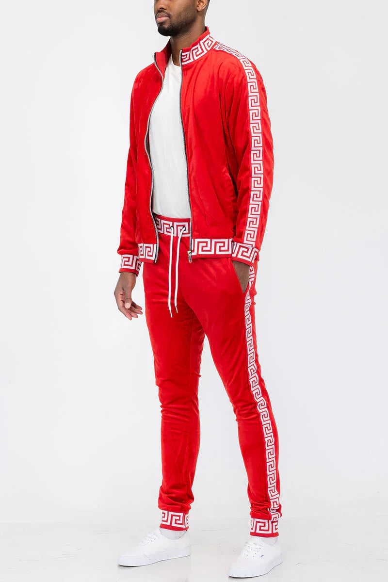 Red and white velour track set featuring full zip jacket and elastic cuff pants displayed flat.