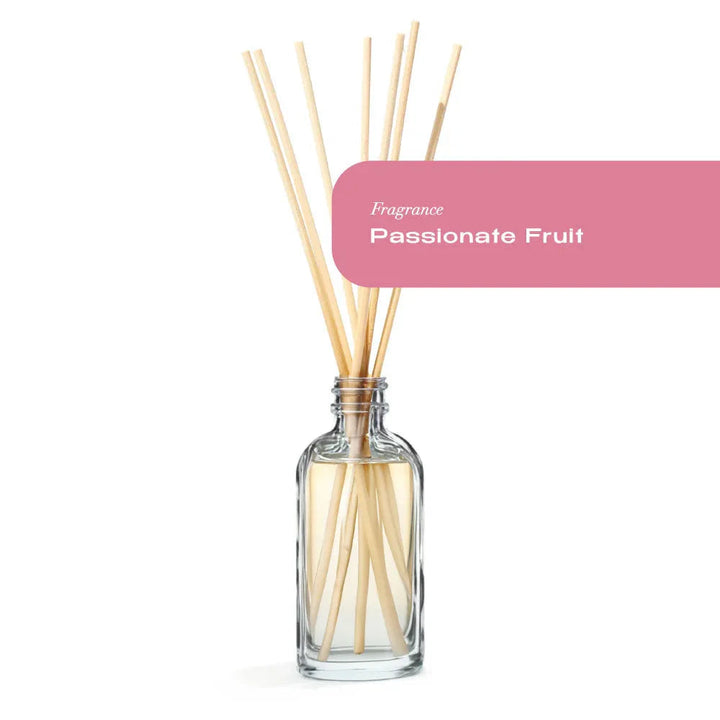 Passionate Fruit Reed Diffuser with natural rattan reeds in a clear upcycled glass bottle.