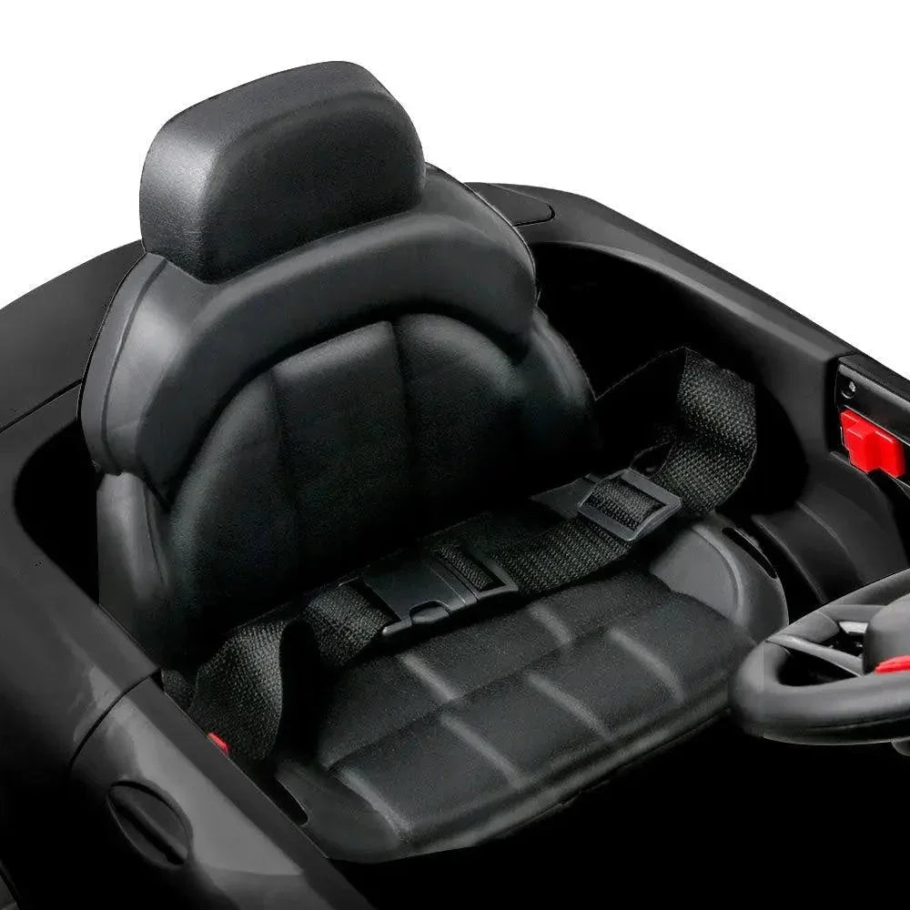 Top view of black electric ride-on car highlighting shiny lacquer finish and interior.