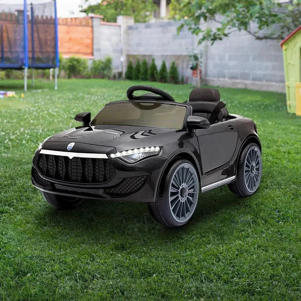 Kids riding black electric ride-on car powered by 12V battery outdoors.