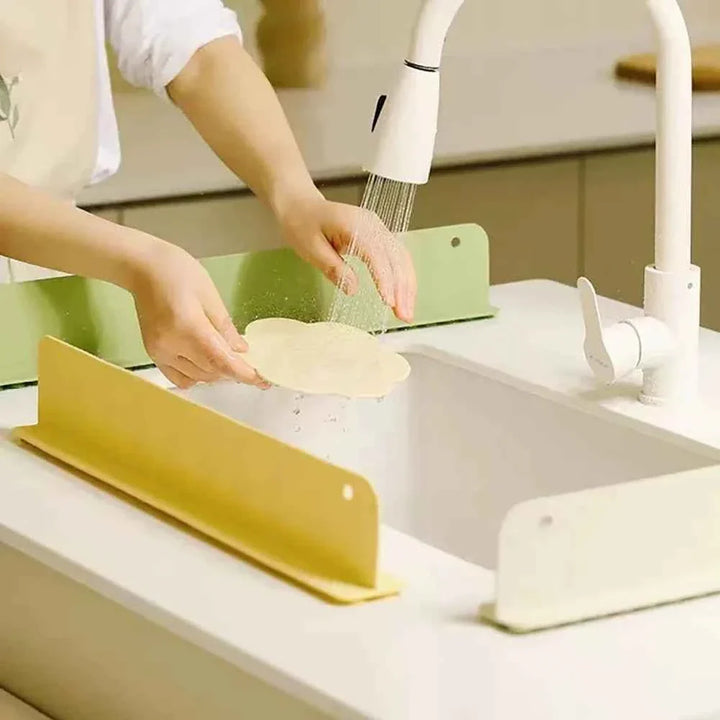 Snagva silicone sink baffle splash guard with suction cups installed on a kitchen sink edge to block water splashes