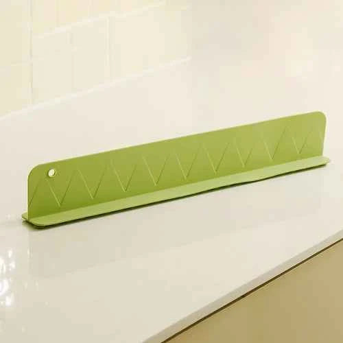 Flexible silicone splash guard with suction cups, designed to fit along a sink edge to reduce water splashing.