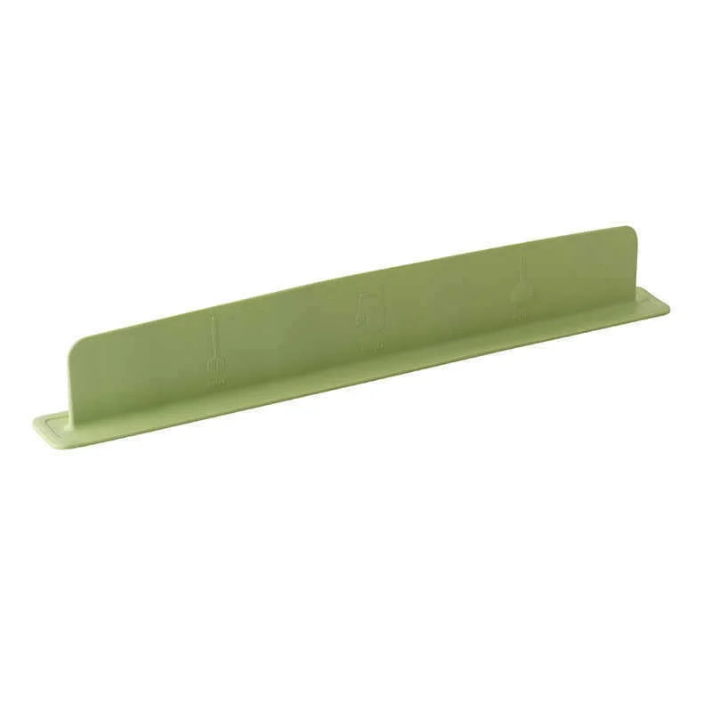 Silicone sink baffle splash guard removed from the sink, showing its slim, flexible design.