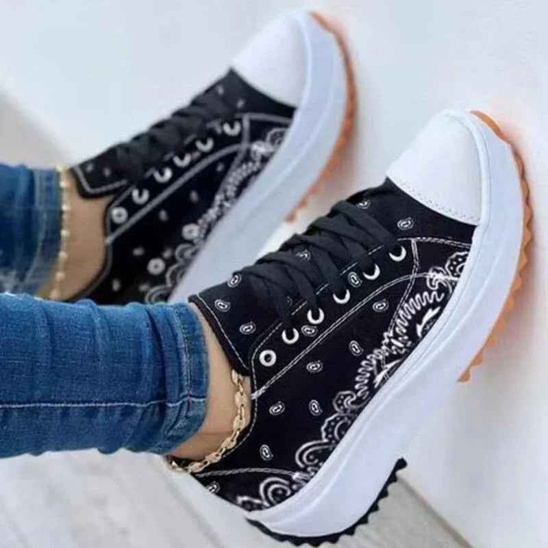 White canvas women’s sneakers with a colorful 2022 pattern design, lace-up closure, and flat rubber sole.