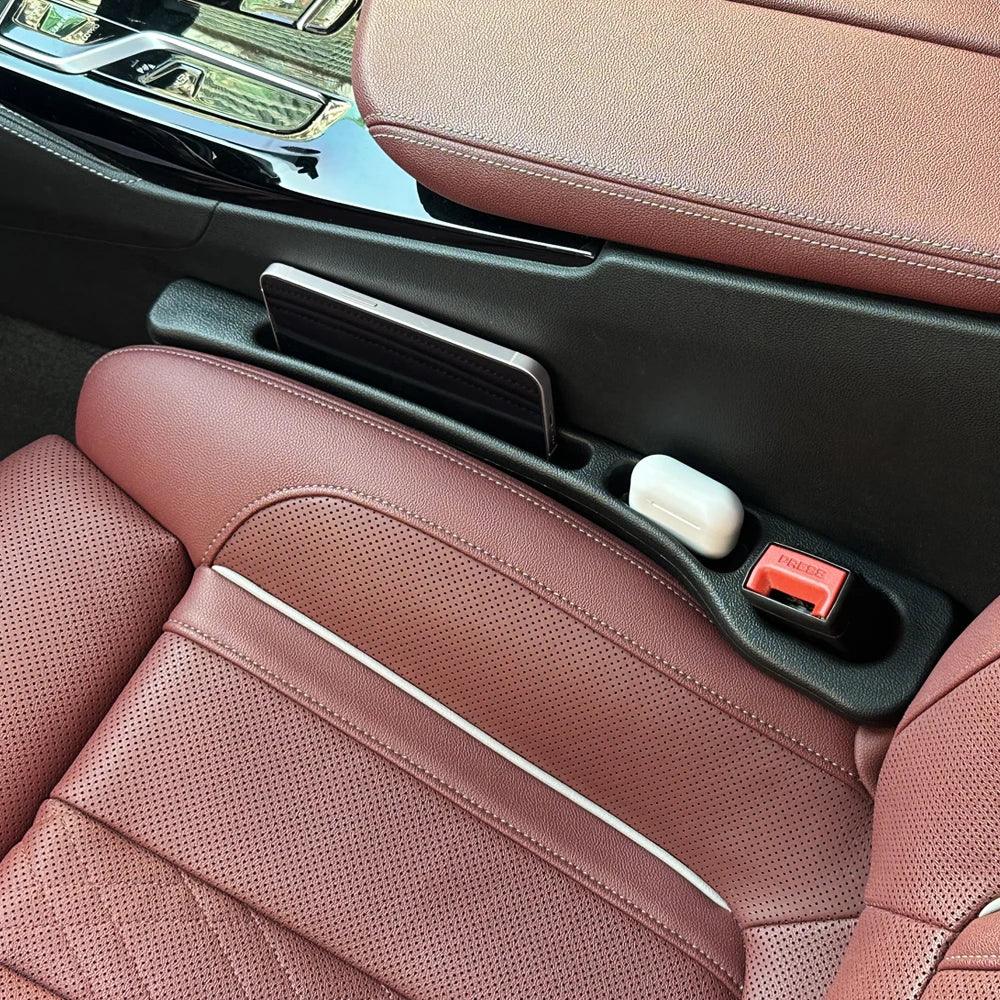 Car seat gap sealing strip with textured surface, fitted in vehicle interior.