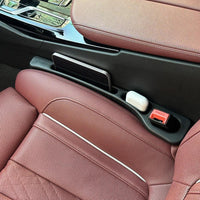 Car seat gap sealing strip with textured surface, fitted in vehicle interior.