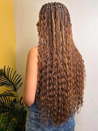 Close-up of synthetic full lace braided wig with ombre blonde curls and baby hair detail