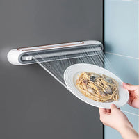 Close-up of two-way sliding blade cutter on magnetic plastic wrap dispenser