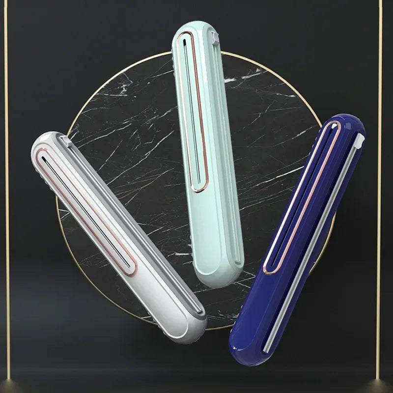Magnetic wrap dispenser holding foil and cling film rolls on kitchen countertop