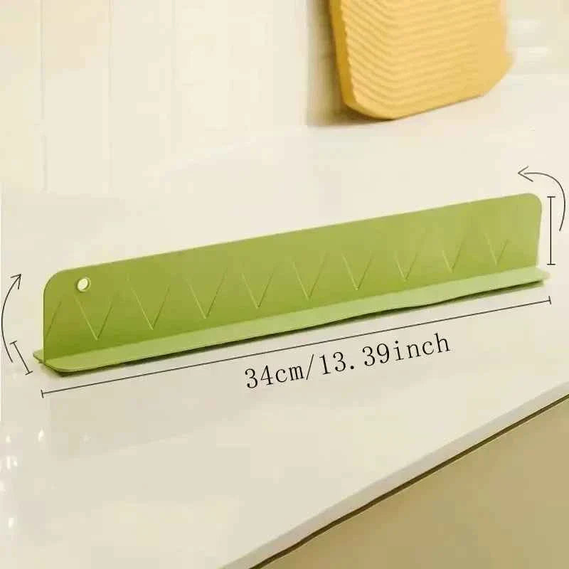 Flexible silicone splash guard with suction cups, designed to fit along a sink edge to prevent water from spilling out.