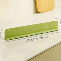 Flexible silicone splash guard with suction cups, designed to fit along a sink edge to prevent water from spilling out.