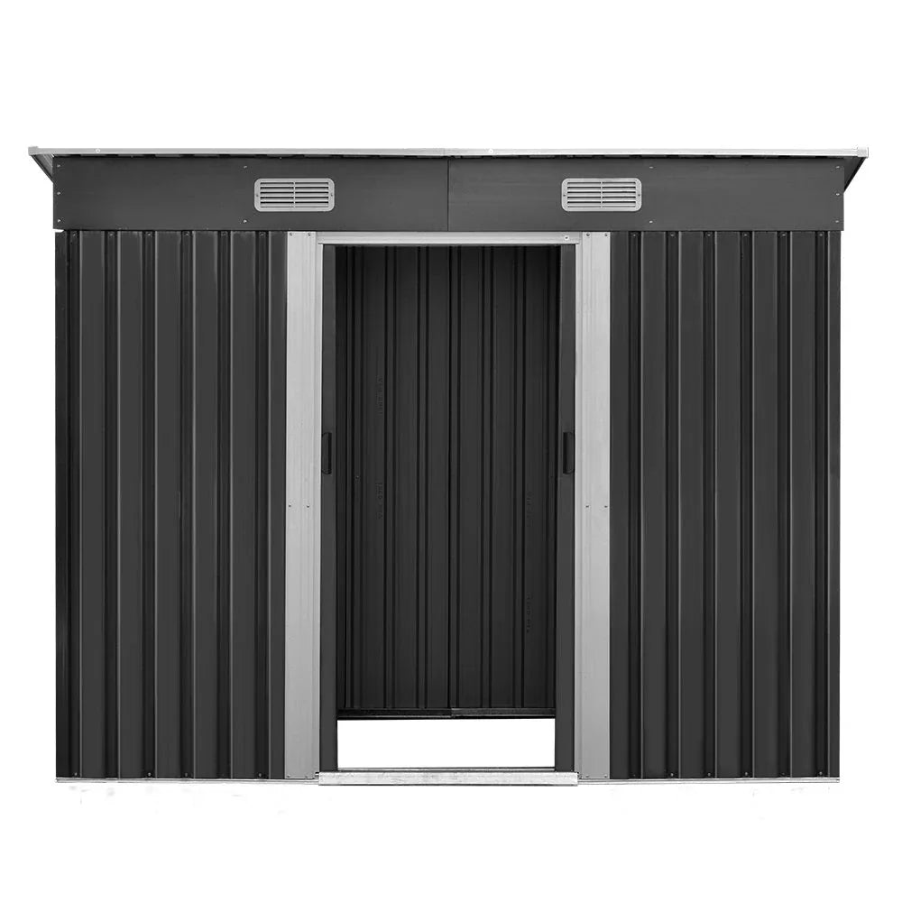 Interior of metal garden shed with steel frame, empty spacious floor and ventilation vents.